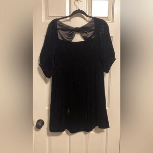 Black velvet cocktail dress with bow detail on back.